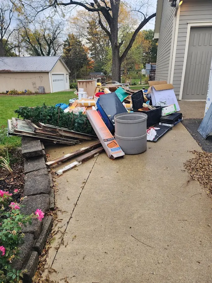Dumpster being loaded with debris for Commercial Dumpster Rental in North Caldwell